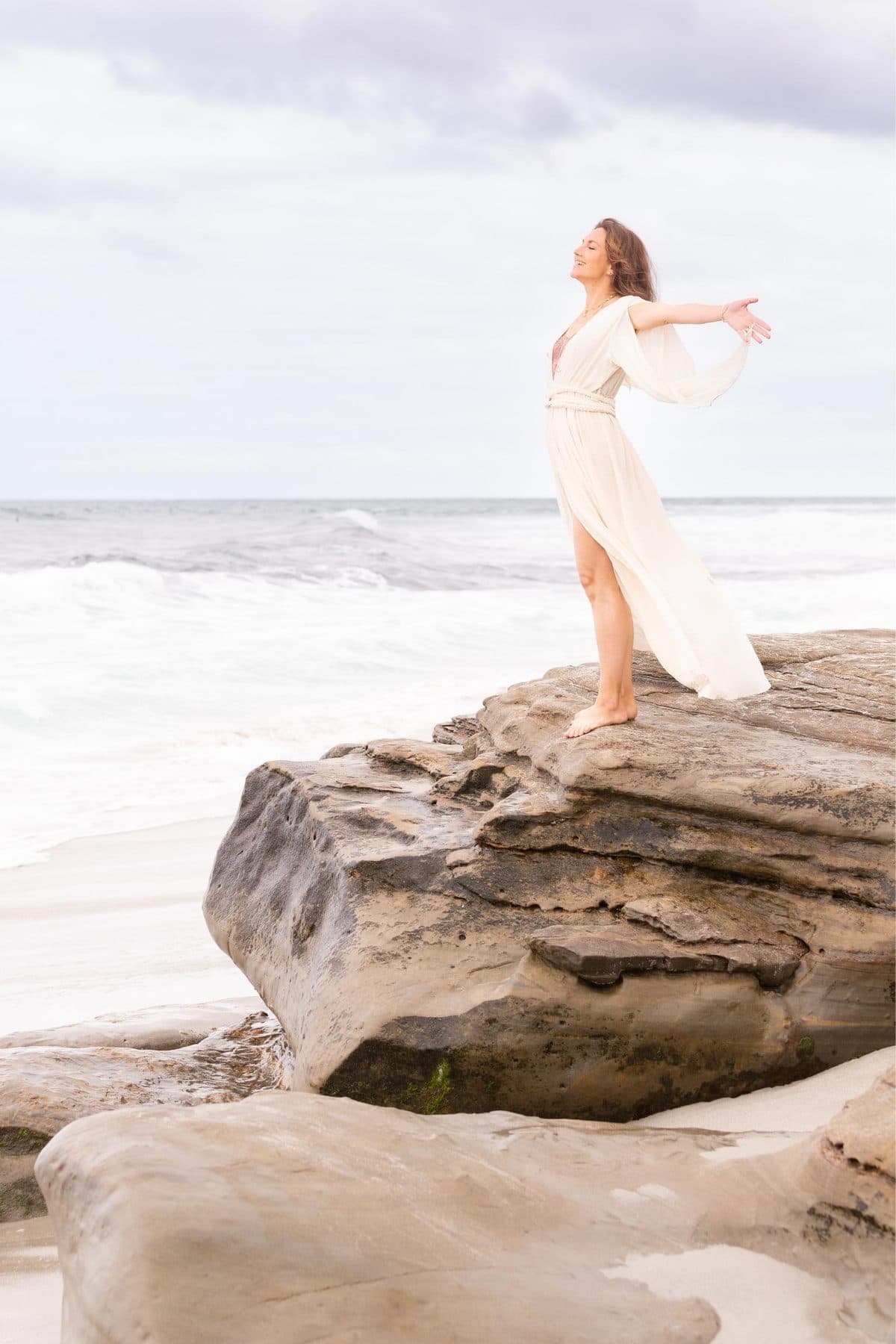 Woman walking barefoot along the shoreline