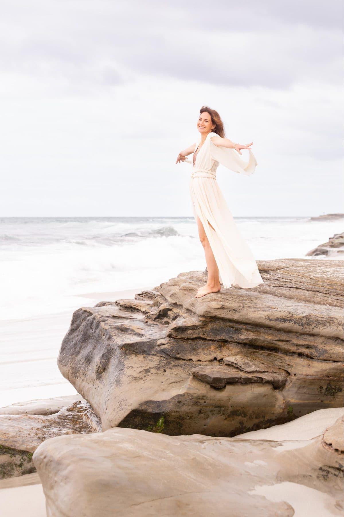 Standing on the rocks by the ocean